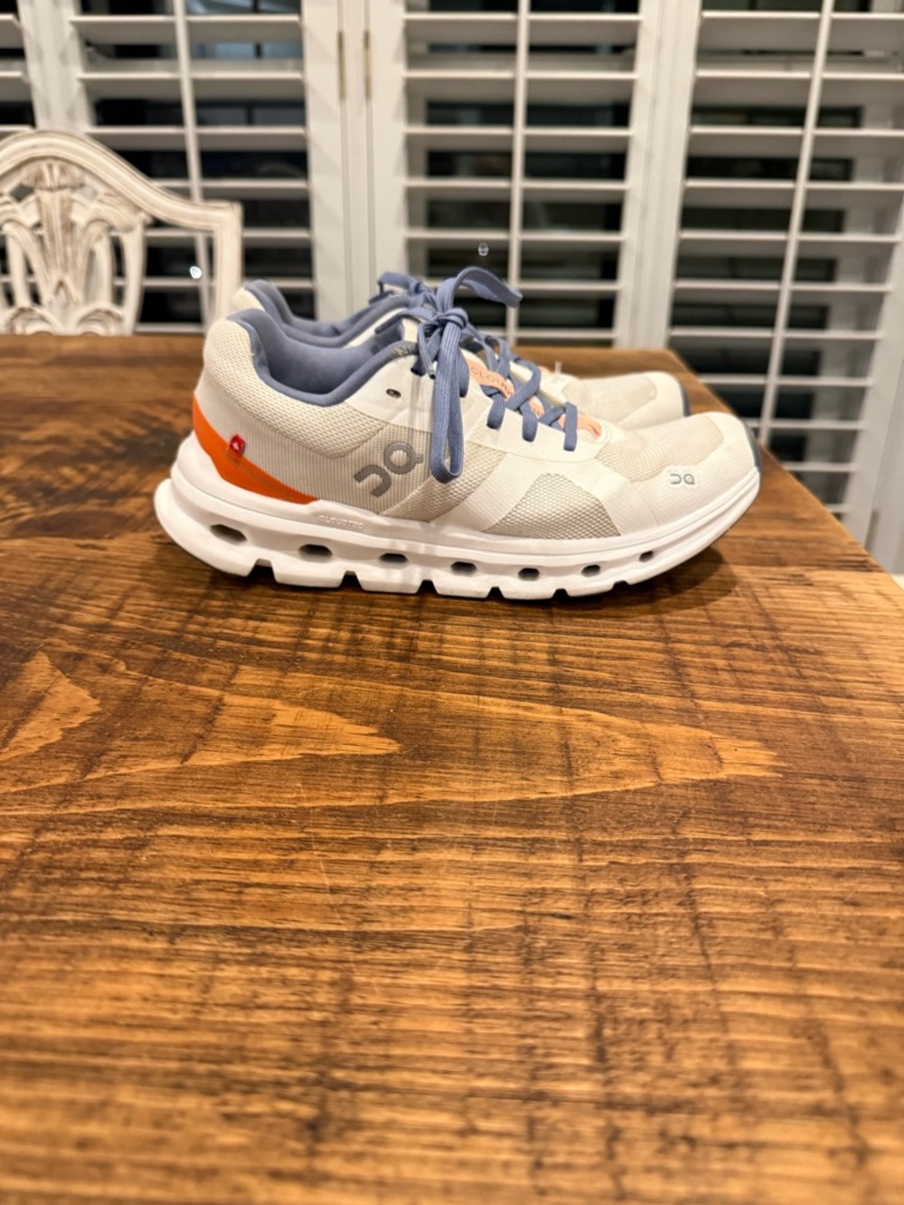 On Cloud Women’s Athletic Shoes in White with Orange Accent